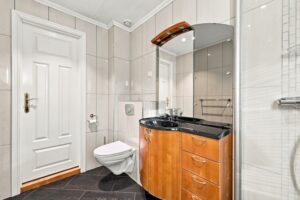 Badet har flislagte vegger og gulv, gulvvarme og flott baderomsinnredning. Det er mekanisk avtrekk på badet.
