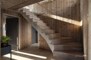 Kombinasjonen av heltre trinn og glassrekkverk gir et lett og elegant uttrykk, samtidig som det slipper lyset fritt gjennom rommet. Det er varme i alle gulv. 