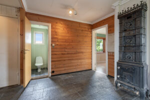 Fra gangen i 1. etasje er det adkomst til et eldre wc/baderom, som har behov for renovering.